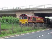 66133 draws its train of empty bitumen tankers out of the exchange sidings at Preston Dock and is off back to Lindsey Refinery near Immingham. The loaded tanks it has just delivered will be taken to the unloading siding by the RSR shunter. [See image 25133]<br><br>[Mark Bartlett 21/08/2009]