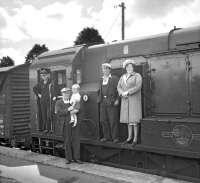 Members of the crew of the last freight pose with a small group of family and friends at Earlston station on 16 July 1965. The lady and gentleman on the right are Jock and Nessie Craw who lived in the 'Crossing House' at the East End of the village. Jock was a linesman and his wife operated the crossing gates.   The gentleman holding the child is Stationmaster Norman Jaffray. The child is Colin Craw, son of Jock and Jessie. [With thanks to Sheila McKay, Auld Earlston]   <br><br>[Bruce McCartney 16/07/1965]