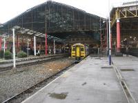 At the east end of Manchester Victoria there are still some  platforms in use. On the right are the bay platforms on the national rail network while on the left is the through island platform used by the Metrolink trams. Beyond the station the Metrolink goes onto street running through the city centre. Out of shot on the far right are the through platforms on the national network above which is the Manchester Evening News Arena. The photograph makes an interesting comparison with that taken by Ian Dinmore [see image 12938]<br><br>[John McIntyre 30/09/2008]