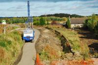 Getting ready for pile driving at Westcraigs. Lineside clearance has revealed the old loading banks to the right of the still intact westbound platform.  View looks east.<br><br>[Ewan Crawford 26/09/2009]