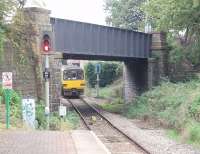 143614 uses the new (1984) link from the Coryton branch to join the Rhymney line at the relocated Heath Junction. Prior to that date trains from Coryton turned right under the bridge, where the extra <I>SPAD</I> signal is, and ran alongside the Rhymney line for over 400 yards to the junction signal box. That land was sold for housing when the new link and junction were made. The Arriva Class 143 is on one of the half hourly Coryton Cardiff Radyr services.<br><br>[Mark Bartlett 18/09/2009]