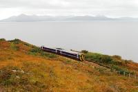 A Sprinter heading to Inverness runs by the coast between Portnacroish and Duirinish. On the horizon is the Cuillin range on Skye.<br><br>[Ewan Crawford 01/10/2009]