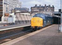 Platform scene at Haymarket station in October 1982 with 37190 on a westbound train at platform 2. Work is underway in the background in connection with the removal of some of the original Edinburgh and Glasgow Railway structures in order to make way for additional car parking facilities. (The old E&G train shed can now be seen at the SRPS station at Boness.) The area has witnessed many further changes since the photograph was taken, with part of the extended car park that was eventually built subsequently reclaimed to accommodate the additional platform 0 (opened in January 2007) and the Caledonian Ale House in the background (to the left of the station building) demolished in 2008 to make way for the new tram / train / bus interchange.<br>
<br><br>[Peter Todd 01/10/1982]