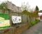 Hutton Bank, Ripon, in April 2009, looking NE towards the entrance to the once extensive goods depot, closed in the late 1960s. Some of the depot's original buildings, seen here just inside the main entrance, are currently used by a pet food company, whose advertising banners hang along the perimeter fence. Above these is the remains of the wooden notice board that would have once announced <I>British Railways, Ripon Goods Depot</I>.    <br>
<br><br>[John Furnevel 24/04/2009]