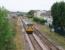 The Heysham Boat train passes the site of Morecambe Euston Road, the substantial yellow brick five platform LNWR terminus in the town. This was sited at an angle alongside this connecting link to Morecambe Promenade station in the area now occupied by housing. Euston Road closed after the 1963 summer season although from 1957 onwards it had only been open from June to September each year for excursion traffic. Nothing remains of the passenger station but the goods shed still stands in a builders merchant's yard and can be seen from passing trains. 142016 will reverse at Morecambe to access the Heysham branch by the blue building in the distance.<br><br>[Mark Bartlett 14/08/2009]