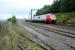 A Voyager speeds north at Shap Summit, the view looks north. The tracks in the foreground serve the Shap Summit Quarry loading pad (behind camera) with the leftmost lifted beyond the boundary fence gate. A line used to run south from near here to Shap Pink Granite Quarry.<br><br>[Ewan Crawford 05/09/2009]