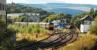 The Royal Scotsman lies over in the Keith and Dufftown Railway's platform at Keith. Meanwhile an Aberdeen service waits for passengers at the mainline platform. The building on the left was formerly the locomotive shed, now part of the Chivas site.<br><br>[Ewan Crawford 30/09/2009]