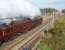 Plenty of steam from 6233 <I>Duchess of Sutherland</I> as she heads north on a sunny but cool morning at Woodacre, near Scorton, on the Crewe to Carlisle leg of the <I>Royal Scot</I> steam excursion. This view taken from the footbridge that replaced the original level crossing when the line was upgraded for 125mph running. This was one of the last main line runs for the Duchess before its <I>ticket</I> expired but she was subsequently granted an extension and, repainted from maroon to black, continued on the main line during 2010 [See image 29245].<br><br>[Mark Bartlett 10/10/2009]