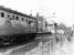 The <I>Rossendale Farewell Railtour</I> from Manchester Victoria is halted at Ramsbottom, for the level crossing gates to be opened, on its outward journey to Rawtenstall. The enthusiast with cine camera at the second door of the DMU is the late Fred Young, well known among the active members involved in the early days of the E.L.R. Preservation Society. The land in the foreground of this picture is now occupied by the reconstructed Up platform built after the East Lancashire Railway reopened [See image 49258]. <br><br>[Mark Bartlett 14/02/1981]