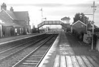 Platform view south over the level crossing at Longtown around 1962. (The footbridge and signals controlling the junction with the single line link to Mossband shown in the later mystery photograph [see image 5986] can be clearly seen here).  <br>
<br><br>[Robin Barbour Collection (Courtesy Bruce McCartney) //1962]