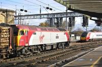 Virgin <I>Thunderbird</I> no 57310 <I>Kyrano</I> with the Kingmoor - Chirk timber train is overtaken by a southbound Pendolino in Carlisle station on 26 October.<br>
<br><br>[Bill Roberton 26/10/2009]