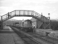 The 10.10 Speyside freight trip from Aviemore trundles through Grantown-on-Spey East on 11 April 1968. The original train loco had failed and this replacement had been sent all the way from Perth. Following the withdrawal of passenger services in 1965, Grantown was the first block post and crossing loop east of Aviemore, but with one train a day in each direction any such crossing must have been an unusual event. [See image 38990]<br>
<br><br>[David Spaven 11/04/1968]