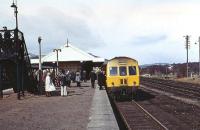 The Speyside Express railtour from Edinburgh to Boat of Garten on 07 April 1973 is seen on the outer face of the island platform at Aviemore whilst operating one of the three return trips to Boat of Garten. While today's trains on the Strathspey Railway operate from this platform, at that time the DMU had to first run into the headshunt at the south end of the station in order to access the original route north to Inverness via the line to the right of the train.<br><br>[John McIntyre 07/04/1973]