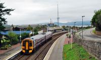 A service from the north pauses at Invergordon. The removal of the footbridge from Invergordon station has created quite a long walk for law abiding passengers who need to cross the tracks. And we have lost a vantage point for photographs.<br><br>[Ewan Crawford 29/09/2009]