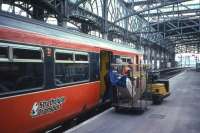 Scene in 1996, but already looking like another era - loading parcels from a 'BRUTE' [British Rail Universal Trolley Equipment] onto an Ayr train at Glasgow Central.<br><br>[David Spaven //1996]
