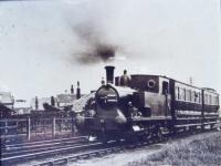 A train for Whittingham hospital leaves the CMHW station at Grimsargh behind Barclay 0-4-2T No.2 (Works No. AB 1026/1904), sometime during WWI. At this point the hospital line curved away from the Preston and Longridge line that ran behind the low wooden fence. The two passenger coaches were later replaced by three converted ex-LNWR brakevans that lasted until the end of this 'free to ride' service in 1957. The loco, new to the line from Andrew Barclay, lasted in service until 1952 and was replaced by the Sentinel shunter <I>Gradwell</I>.. <br><br>[David Hindle Collection //]