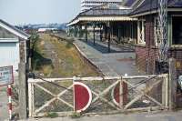 A forlorn Barnstaple Town station photographed from a rickety signal post on 8th September 1976. Although the line through here to Ilfracombe closed in 1970, its infrastructure remained in limbo as preservation attempts continued up until 1975. A final train was run that year, then the track was removed and the cause was lost. The station building remains in a restored form, as do part of the canopy and the signal box.<br><br>[Mark Dufton 08/09/1976]