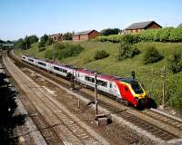 A southbound Virgin Super Voyager passes Farrington Curve Junction on the Up Fast on 22 June 2006 in bright sunshine.<br><br>[John McIntyre 22/07/2006]