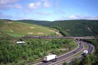 A Class 87 races north over Harthope viaduct and the A74 dual carriageway at the end of May 1992 with a service for Glasgow Central.<br><br>[John McIntyre 29/05/1992]