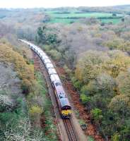 The morning Goonbarrow Junction to Fowey loaded China Clay train heads south from Luxulyan. The view is from Treffy's viaduct and the train is on a 'new' section of line which replaced a nearby incline and, sadly, Treffy's Viaduct.<br><br>[Ewan Crawford 18/11/2009]