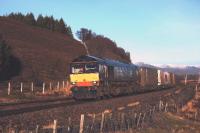 With snow on the hills, on a chilly but sunny winters day, DRS 66423 is pictured heading south from Dalwhinnie with the J G Russell container train.<br><br>[John Gray 11/12/2009]
