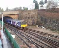 A Clitheroe to Manchester service emerges from the west end of Blackburn tunnel and runs into the station. The area in front of the two retaining walls was occupied by Blackburn East signal box until 1972, since when the track layout has been simplified and the tunnel lines are now bi-directional.<br><br>[Mark Bartlett 04/12/2009]