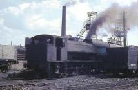 Flanked on either side by wooden bodied coal wagons, and with the two pit head winding gear towers behind, 0-6-0ST <I>Revenge</I> makes a fine site as it shunts steel hopper wagons at Haig Colliery. Although steam working finished soon after this the pit itself survived until 1986 becoming Cumbria's last deep mine and is now partly preserved, including one of the headgears. <br><br>[David Hindle //1968]