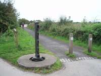 One of two surviving level crossing gate posts at Conder Green on the former Glasson Dock branch. From here to Glasson the line curves round the Lune estuary and, as the embankment now forms both a cycle track and local flood defences, the old railway is likely to be around for some time. View towards the bridge over the River Conder in the direction of Glasson.<br><br>[Mark Bartlett 07/09/2009]