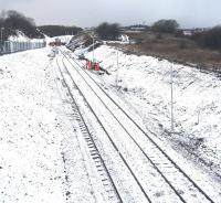 A snowy view of the new run-round loop on the old Dalry line, looking west from Bridge 102, with the track gang applying the finishing touches to the buffer stop at the end of the line. <br>
<br>
<br><br>[Robert Blane 20/12/2009]