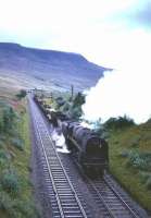 BR Standard class 9F 2-10-0 no 92009 heads south on the Settle and Carlisle line at Ais Gill in the 1960s with a mixed freight.<br>
<br><br>[Robin Barbour Collection (Courtesy Bruce McCartney) //]