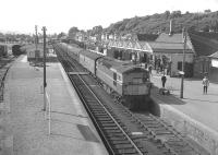 The morning train for Wick runs into Dingwall in August 1966. Note the Royal Mail coach immediately behind the locomotive and the loop platform on the left still operational at that time.<br><br>[Colin Miller /08/1966]