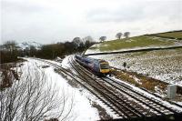 A TransPennine Express service from Manchester heads east towards Sheffield through Chinley East Junction on 29 December 2009 in the hands of 2 car Turbostar 170301. The single line to the left leads to Peak Forest on the former  Midland Railway route to London from Manchester and is now used by stone trains from the quarries.<br><br>[John McIntyre 29/12/2009]