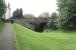 Here stood the basic wooden platforms of St Andrew Street station in Castle Douglas (actually located on Abercromby Road), seen looking south towards Kirkcudbright on 2 September 2009. The site is completely overgrown beyond the bridge, where it now borders the local golf club. The basic facility was opened as a temporary measure by the Kirkcudbright Railway in 1864 due to difficulties with sharing arrangements at the Castle Douglas and Dumfries station (opened 1859). It remained in place for 3 years. Following eventual closure of the line by BR in 1965, this part of the route became a pedestrian shortcut to the town centre (behind the camera).<br><br>[John Furnevel 02/09/2009]