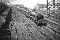 Pride of Polmadie. Stanier <I>Coronation</I> Pacific no 46232 <I>Duchess of Montrose</I>, about to pass her home shed with the up <I>Mid-Day Scot</I> shortly after leaving Glasgow Central on 16 May 1959. In the background stands the ironworks founded in 1837 by William Dixon, which became known to Glaswegians as <i>Dixon's Blazes</i> due to the blast furnaces lighting up the city skyline day and night. Production ceased the year before this photograph was taken, since when the area has been substantially redeveloped. <br>
<br><br>[A Snapper (Courtesy Bruce McCartney) 16/05/1959]