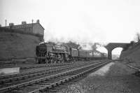 After crossing the River Eden, Britannia Pacific no 70051 <I>Firth of Forth</I> passes below the bridge carrying Etterby Road as it approaches Kingmoor with a northbound train around the mid 1960s. The Britannia was withdrawn from Kingmoor shed at the end of 1967 and disposed of through McWilliams of Shettleston in March 1968.<br><br>[Robin Barbour Collection (Courtesy Bruce McCartney) //]