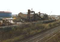 Loading in progress at the <I>European Metal Recycling</I> depot at Laisterdyke, Bradford, on 1 April 1998. EWS 37716 can be seen on the far right at the head of the train currently being loaded, which will eventually be heading for Liverpool's Alexandra Dock following a reversal at Bradford Interchange [see image 26953].<br><br>[David Pesterfield 01/04/1998]