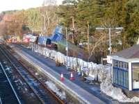 Scene at Carrbridge on 18 January with recovery work continuing. 66048 is covered by the green tarpaulin in the centre of the picture. There may be some second thoughts about how best to remove the locomotive, with Carillion having stopped work on the temporary road from the A9 to the trackside.<br><br>[Gus Carnegie 18/01/2010]