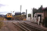 An Aberdeen-bound DMU approaches Millburn Junction level crossing in Inverness in 1976. The route leading up to the Highland Main Line on the right was known as the 'Burma Road' due to its wartime military use, and enabled freights from the Aberdeen direction to run directly into Millburn Yard - a move no longer possible.<br><br>[Frank Spaven Collection (Courtesy David Spaven) //1976]