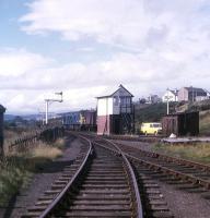 Looking towards the main line from the harbour branch at Invergordon in the summer of 1973 as a class 24 shunts the goods yard.<br>
<br><br>[David Spaven //1973]
