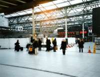 The western concourse at Waverley seen in November 1998 during the <br>
construction of the W H Smith's block which took up so much of the <br>
space, though with a curving front to ease passenger flow. The shop's predecessor can just be seen on the right. Notice also the short-lived bi-coloured LED departure board, which gave way a few years later to the all-yellow style used throughout the network.<br>
<br><br>[David Panton /11/1998]