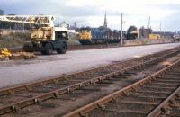 A southbound freight heads out of Invergordon in the summer of 1973. In the right background is one of the ubiquitous NCL (National Carriers) vans which distributed parcels and sundries traffic by road from six stations north of Inverness - Dingwall, Kyle, Invergordon, Brora, Wick and Thurso.<br>
<br><br>[David Spaven //1973]