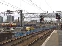 Two Class 156 units pass by the works taking place at the former Platform 11a/12 at Glasgow Central. The platform has been demolished and work is continuing to prepare the ground for the track to be laid into the station. [See image 16098]<br><br>[Graham Morgan 06/02/2010]