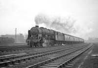 Royal Scot 4-6-0 no 46152 <I>The King's Dragoon Guardsman</I> passing Kingmoor on 23 January 1965 with the 9.25 am Crewe - Perth which it had taken over at Carlisle. The locomens hostel stands in the left background.<br><br>[Robin Barbour Collection (Courtesy Bruce McCartney) 23/01/1965]