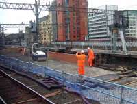 Say <I>cheeeeese</I>! New ballast drop at the former Platform 11a/12 at Glasgow Central on 16 February 2010 where good progress is being made on construction and access for platform 12 and 13. Note also the new supporting wall being built for platform 11 in the background<br><br>[Graham Morgan 16/02/2010]