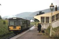 With the Ochil Hills as a backcloth, a railbus pauses at Dollar station shortly before the 15th June 1964 withdrawal of passenger services over the Devon Valley line from Alloa to Kinross. The railway here survived for coal traffic until 1973, when Dollar Mine closed. [See image 18308]<br><br>[Frank Spaven Collection (Courtesy David Spaven) /06/1964]