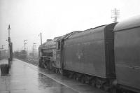 60532 <I>Blue Peter</I> about to leave a grey and rain soaked Stirling station in the 1960s with an Aberdeen - Glasgow Buchanan Street train as a type 2 diesel approaches with a freight from the south.<br><br>[K A Gray //]