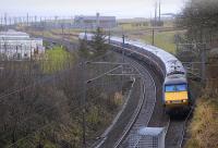 A northbound train on the ECML about to pass under Marshall Meadows road bridge on 27 February 2010, with Berwick-upon-Tweed in the background<br>
<br><br>[Bill Roberton 27/02/2010]