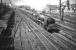 Pride of Polmadie. Stanier <I>Coronation</I> Pacific no 46232 <I>Duchess of Montrose</I>, about to pass her home shed with the up <I>Mid-Day Scot</I> shortly after leaving Glasgow Central on 16 May 1959. In the background stands the ironworks founded in 1837 by William Dixon, which became known to Glaswegians as <i>Dixon's Blazes</i> due to the blast furnaces lighting up the city skyline day and night. Production ceased the year before this photograph was taken, since when the area has been substantially redeveloped. <br>
<br><br>[A Snapper (Courtesy Bruce McCartney) 16/05/1959]