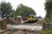 A Southport to Manchester service has just arrived at Bescar Lane as the level crossing barrier starts to open on 26 August 2009. Although both platforms used to be on the east side of the crossing, today the down platform (from where the photograph was taken) is now on the west side.<br><br>[John McIntyre 28/08/2009]