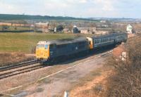 31416 hauling a failed Metro Cammell DMU on the 13.40 Leeds - Sheffield service on 31 March 1988. The combination is seen shortly after passing Crigglestone Junction signal box.<br><br>[David Pesterfield 31/03/1988]